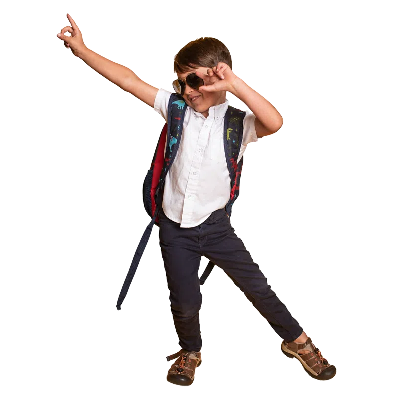 Dancing schoolboy wearing sunglasses and rucksack
